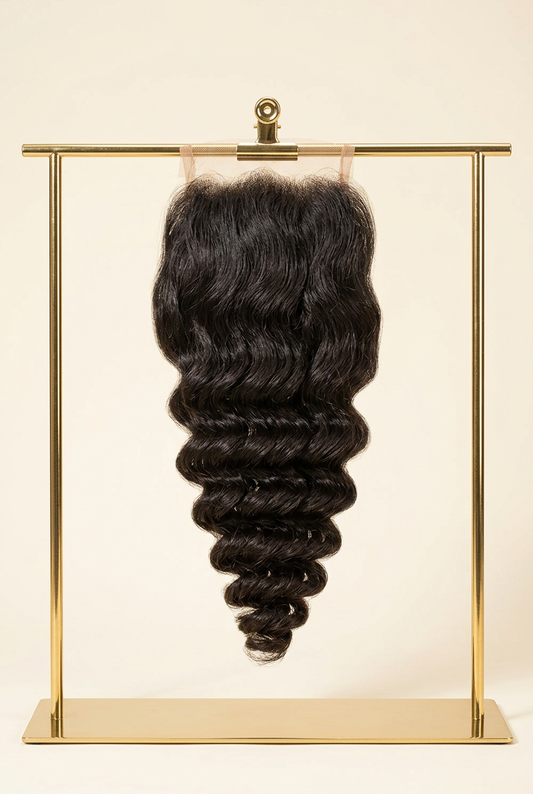 Loose-wave lace closure on a gold hanging rack